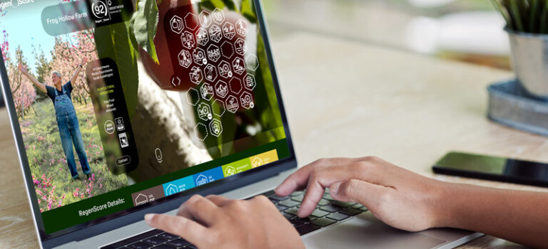 Hands on keyboard of laptop with RegenScore farmer profile on screen